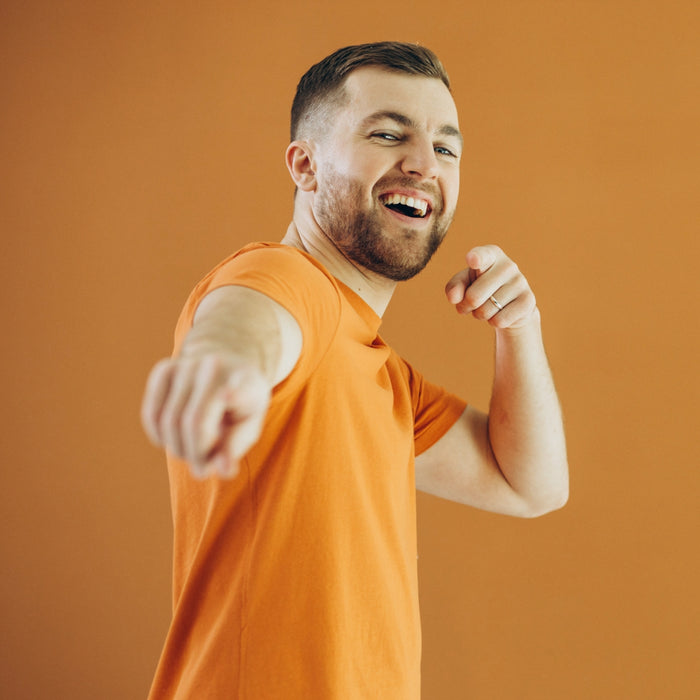Man in an orange shirt on an orange background