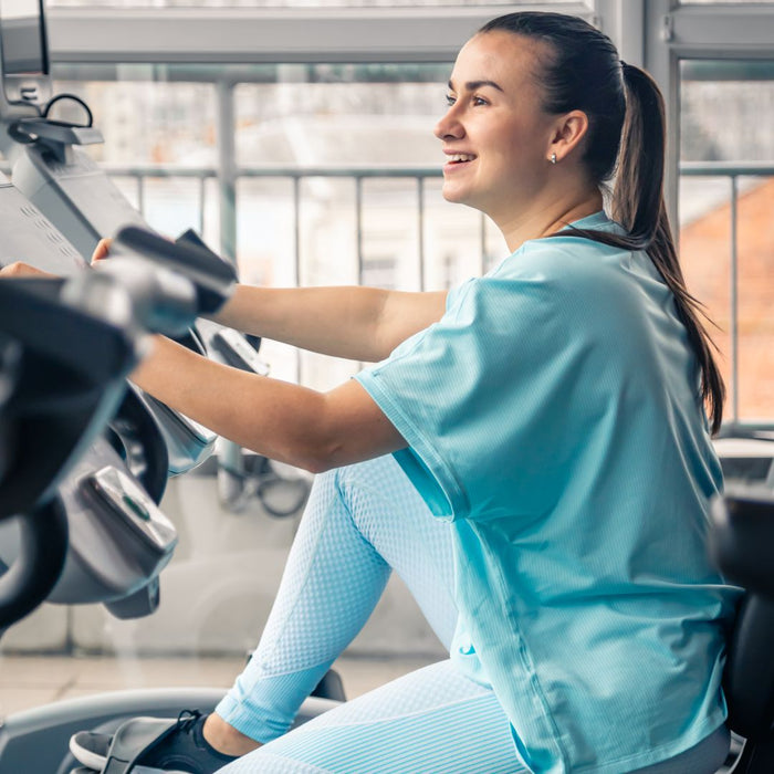 Woman exercising on a machine in a gym