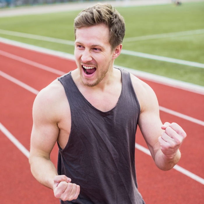 Man celebrating on a running track