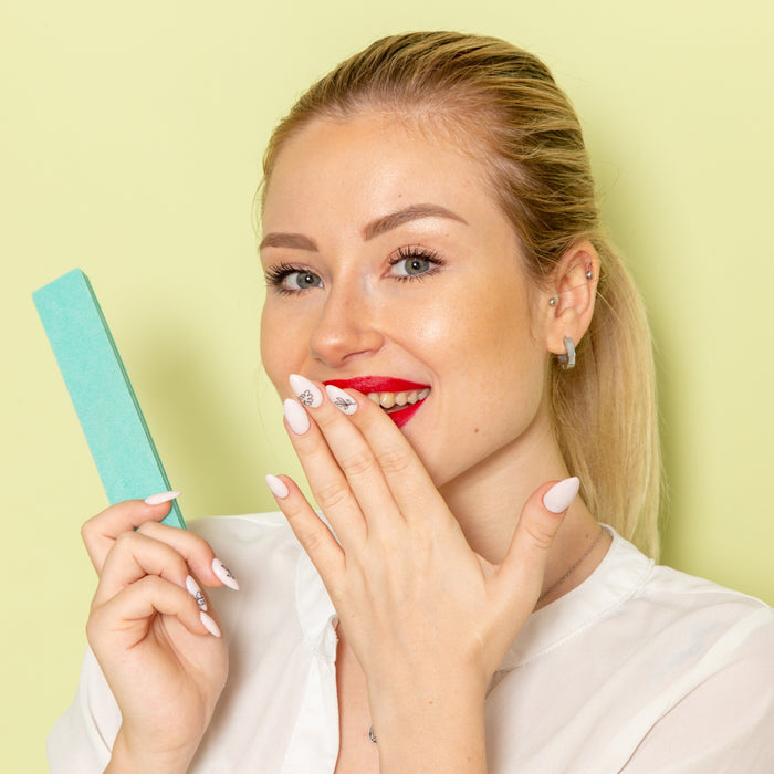 Woman holding a green popsicle against a light yellow background