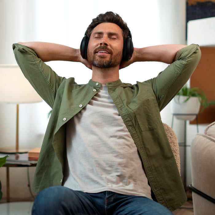 Man wearing headphones and relaxing in a living room